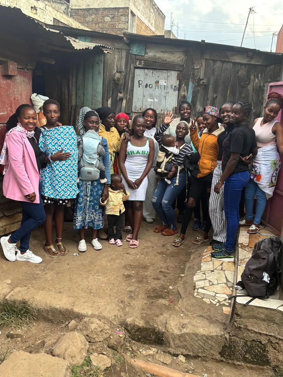 Mothers and children posing for a group photo in the neighbourhood